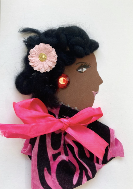 This card has been given the name Doctor Queen's Park. She wears a blouse that has a black and hot pink pattern on it, and a pink bow by the neck. In her short black hair, she wears a pink flower that has a gold shimmery center. Her earring is one large red gem.