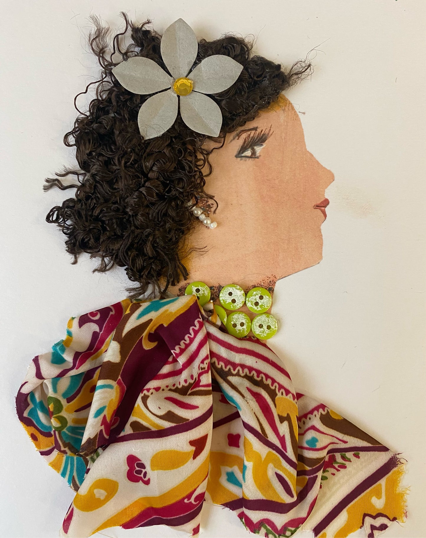 I designed this card of a woman named Larisa Yellow. She has a white skin tone and wears a stunning white flower in her hair. She wears a graceful pattern blouse with a gorgeous green button necklace and shiny white earrings.