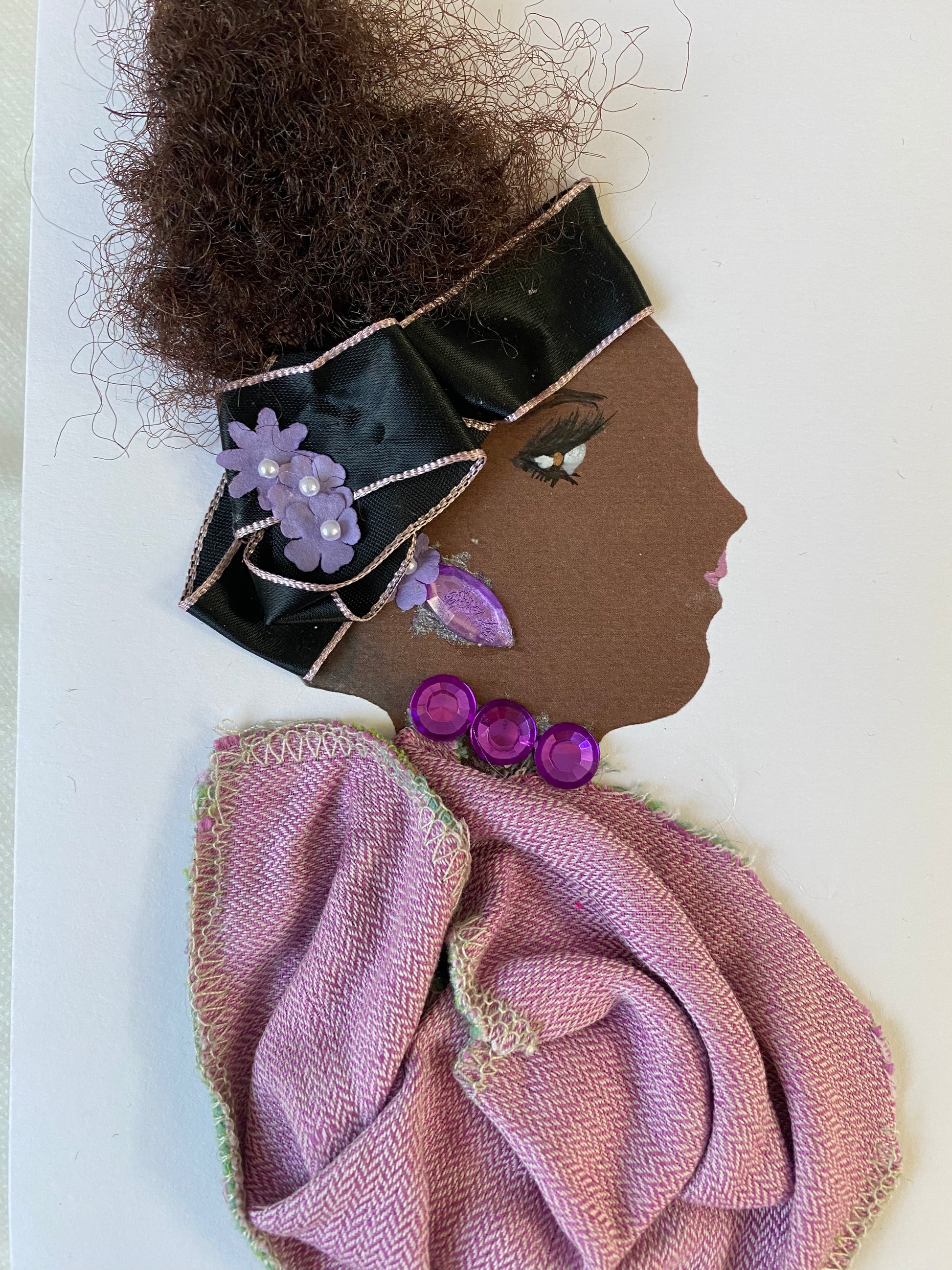 I designed this card of a woman who is wearing an elegant dark blue headband with three purple flowers. She wears an angelic purple blouse with ravishing purple jewellery.