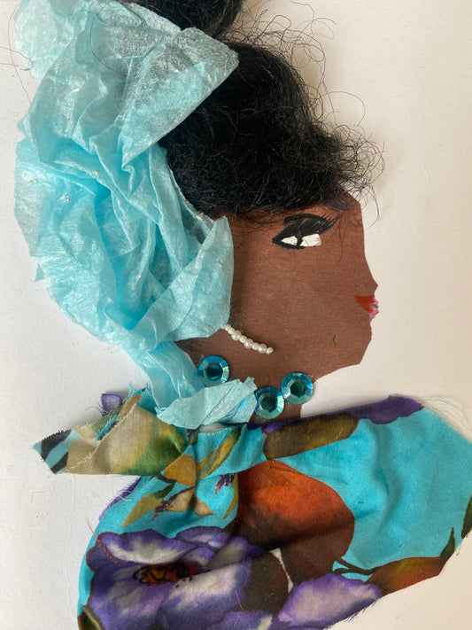 I designed this card of a woman named Brianna Barbican. She is wearing a gorgeous baby blue head wrap. She wears a blue floral pattern blouse. She wears a dazzling blue necklace and white dangling earrings.