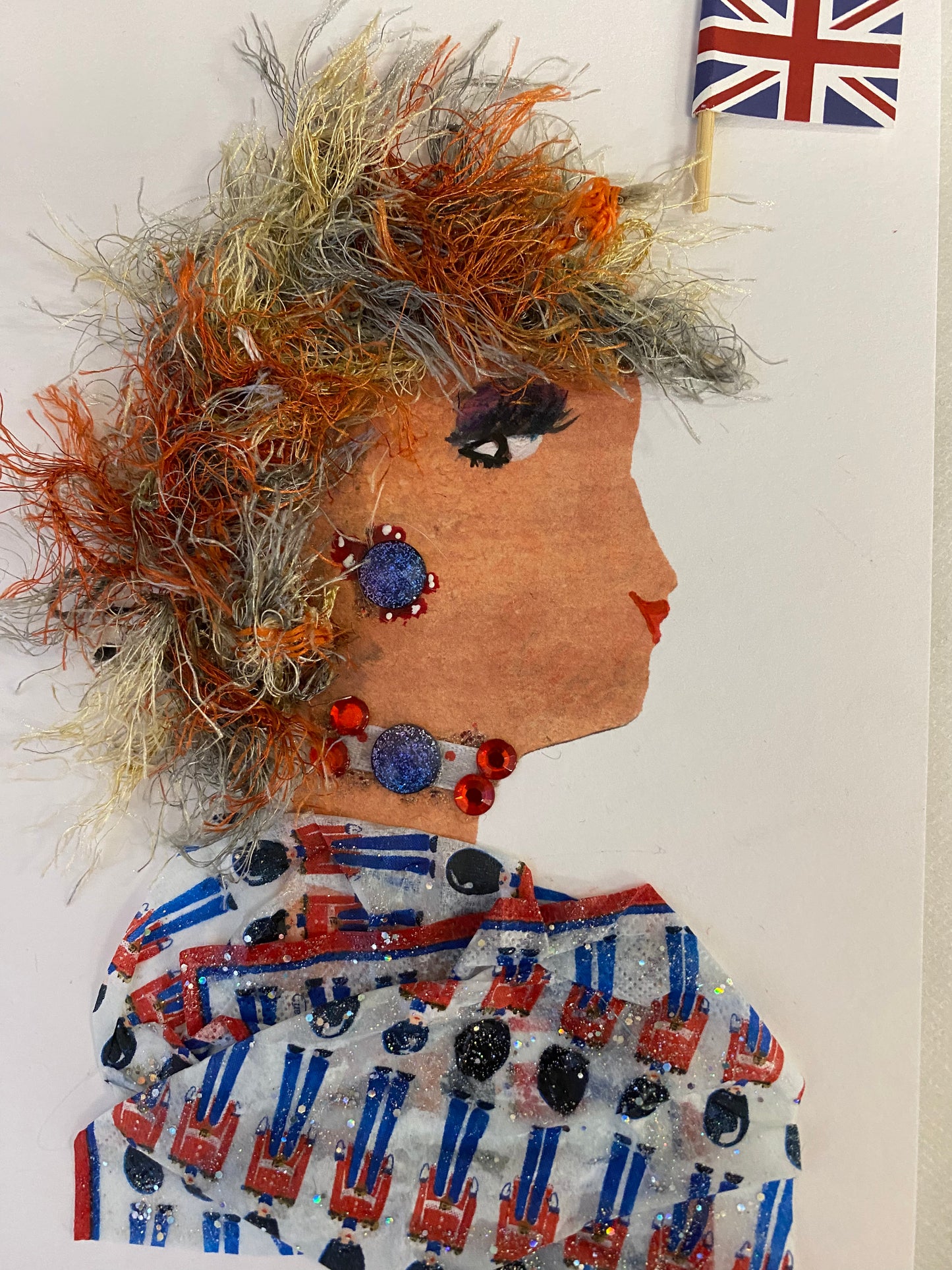 I designed this card of a woman who wearing an outfit that is highlighted by a vibrant red, white, and blue guard pattern, complemented by elegant blue and red jewelry. At the top corner is the emblem of the London flag.