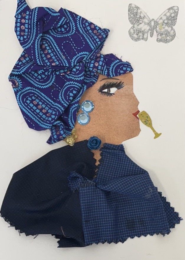 This card is of a woman given the name Daisy. Daisy is wearing two blue fabrics, one dark navy blue and one a slightly lighter navy blue, both with small square prints. She wears a blue rose on her neck and light blue gems as earrings. Her blonde hair peeks out of the bottom of her blue patterned headscarf. There is a small, gold champagne glass near her lips as though she was drinking it. There is a silver glitter butterfly in the background.