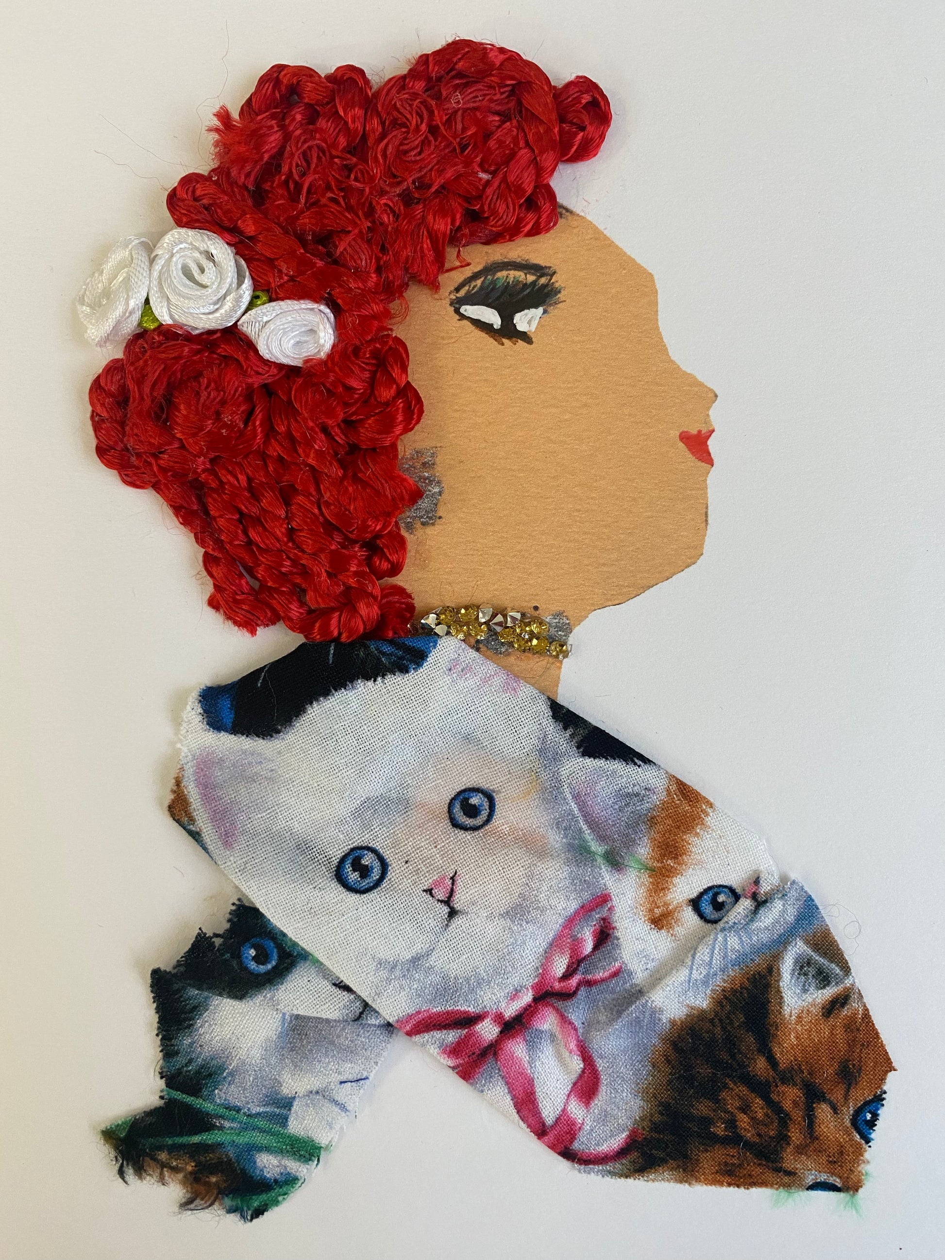 This card features a woman with three white flowers in her hair, alongside a cat-patterned blouse and gold and silver jewellery.