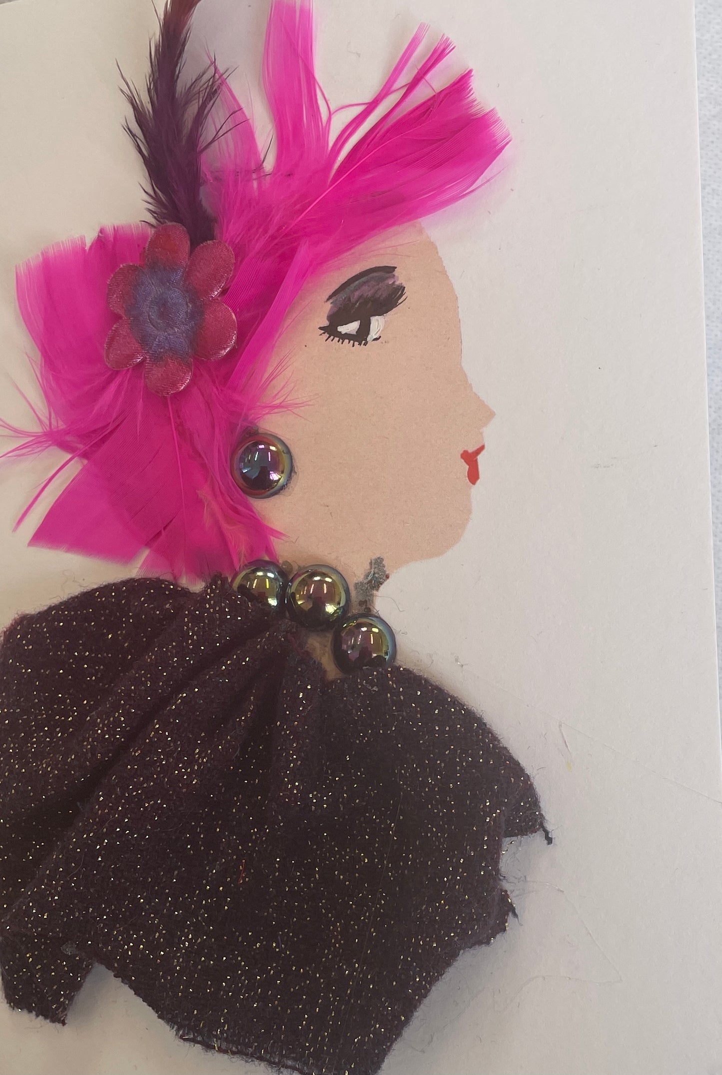 I designed this card of a woman who is wearing a red and purple flower clip in her hair with purple feathers. She wears a purple sparkly blouse with shimmery jewellery.