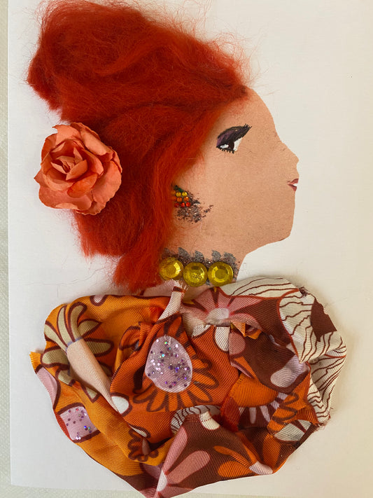 I designed this card of a woman named Charlotte Pamplin. She has a white skin tone and has red hair. In her hair there is a pink flower. She wears an orange flower blouse. She wears a yellow gem jewellery. 