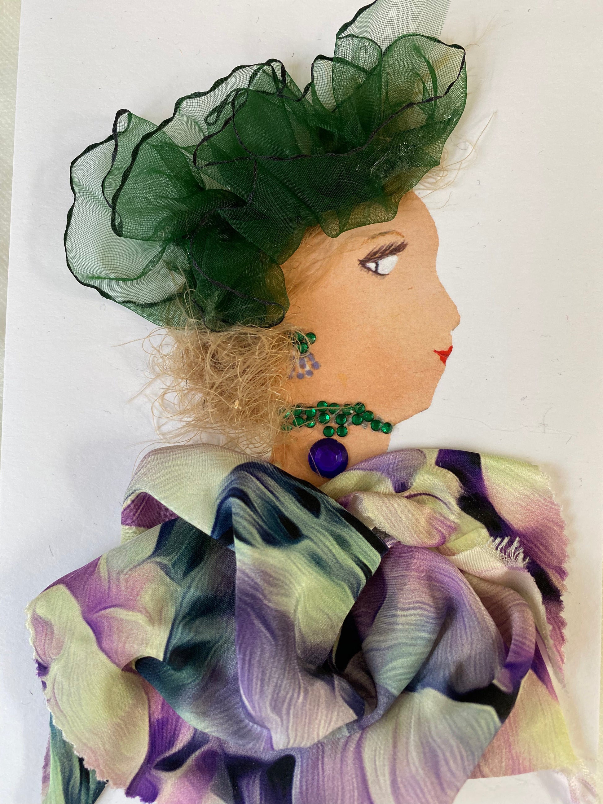 I designed this card of a woman named Doctor Warren Street. She has a white skin tone and is wearing a graceful green hatinator. She wears a delicate colorful blouse. She wears beautiful green and purple jewellery.