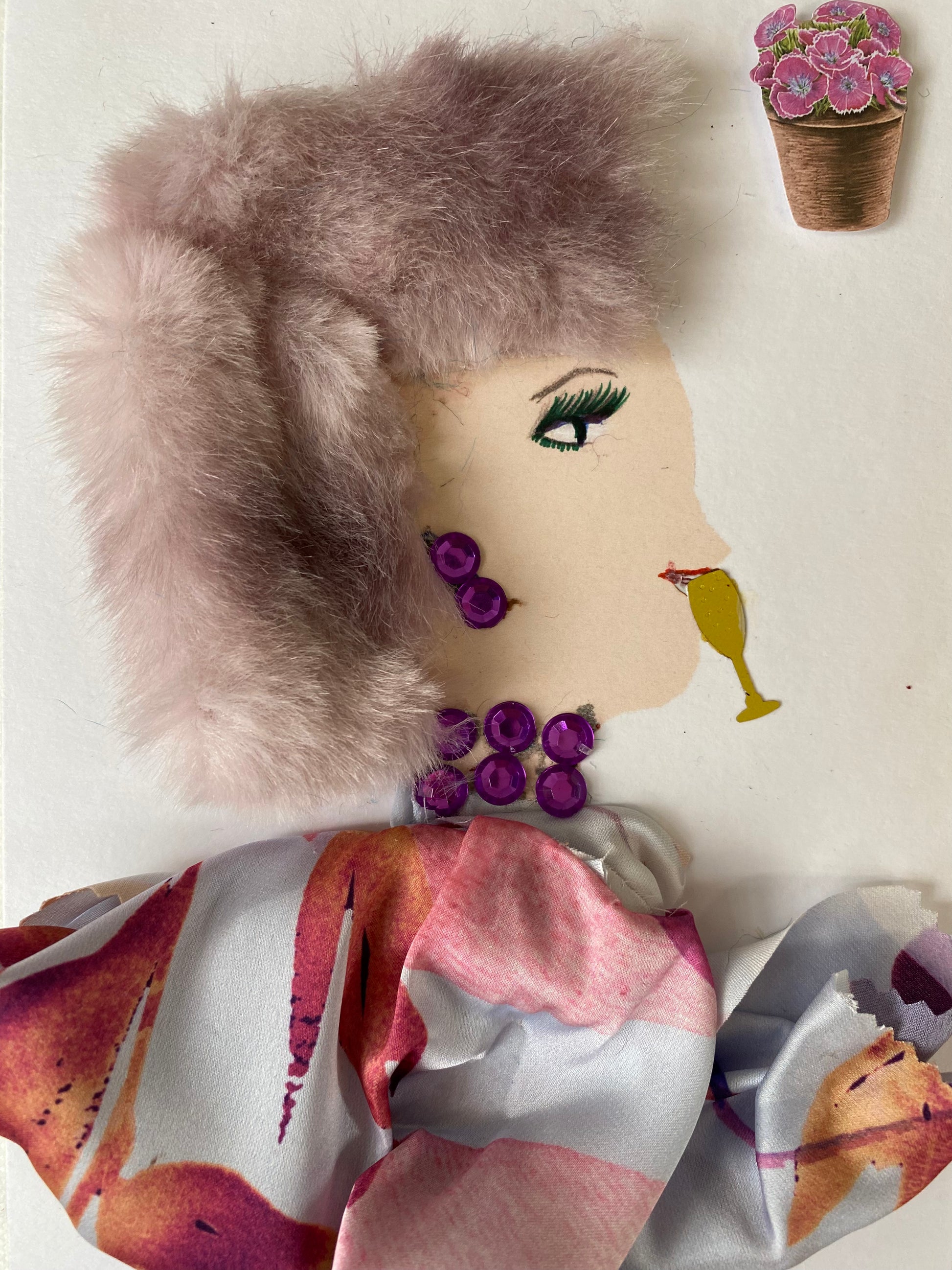 I designed this card of a woman who is wearing a pink furry hat. She is wearing a pink floral blouse. She is wearing purple gem jewellery. By her mouth there is a glass. In the corner there is a bouquet of pink flowers.