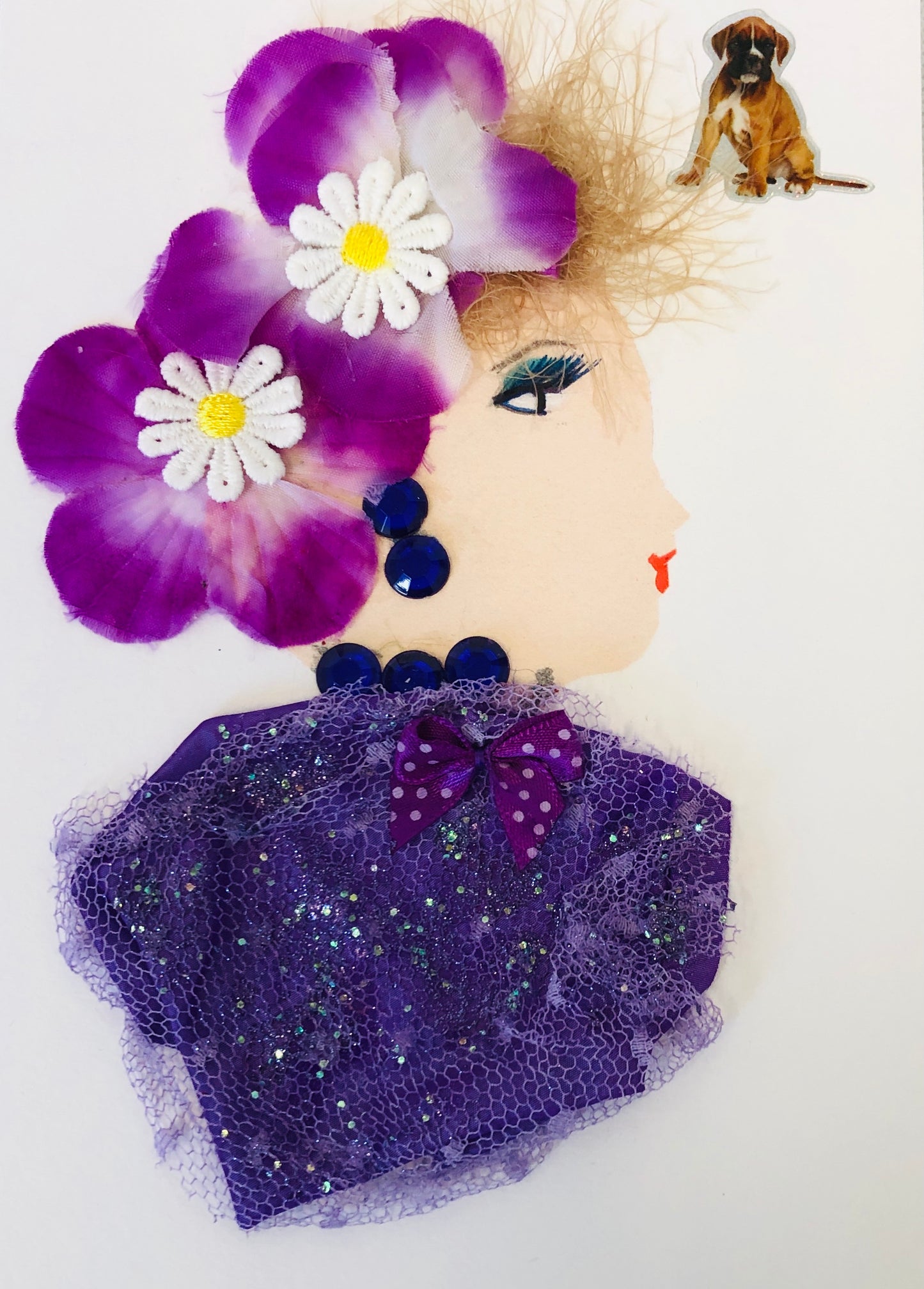 Kenton wears a glittery mesh blouse and two large purple flowers in her blonde string hair. In the top right corner, there is a small dog sticker.