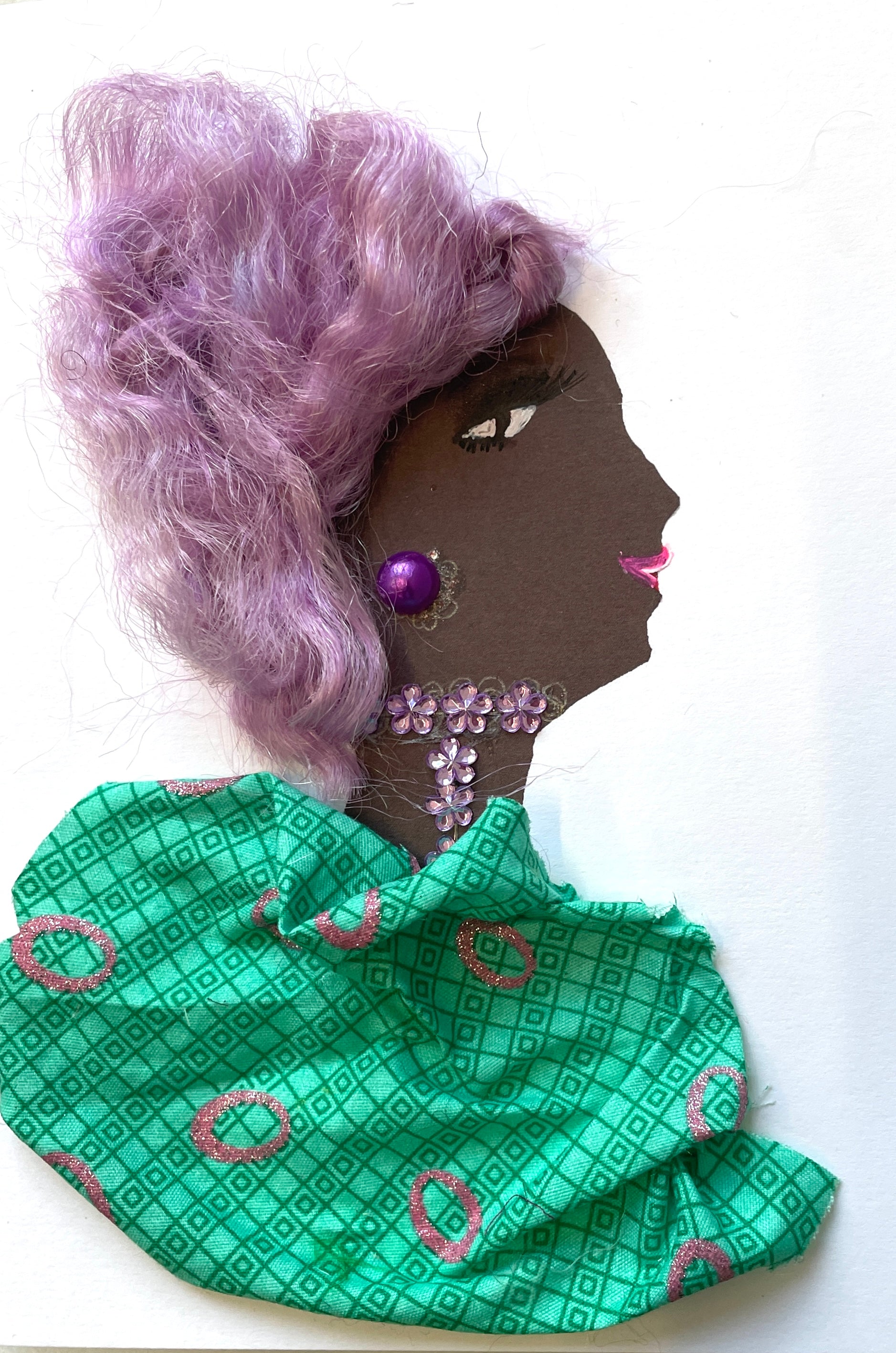 I designed this card of a woman named Bonnie. She has a black skin tone with light purple hair. She wears a green blouse with sparkly purple circles. She wears a floral necklace and purple earrings.