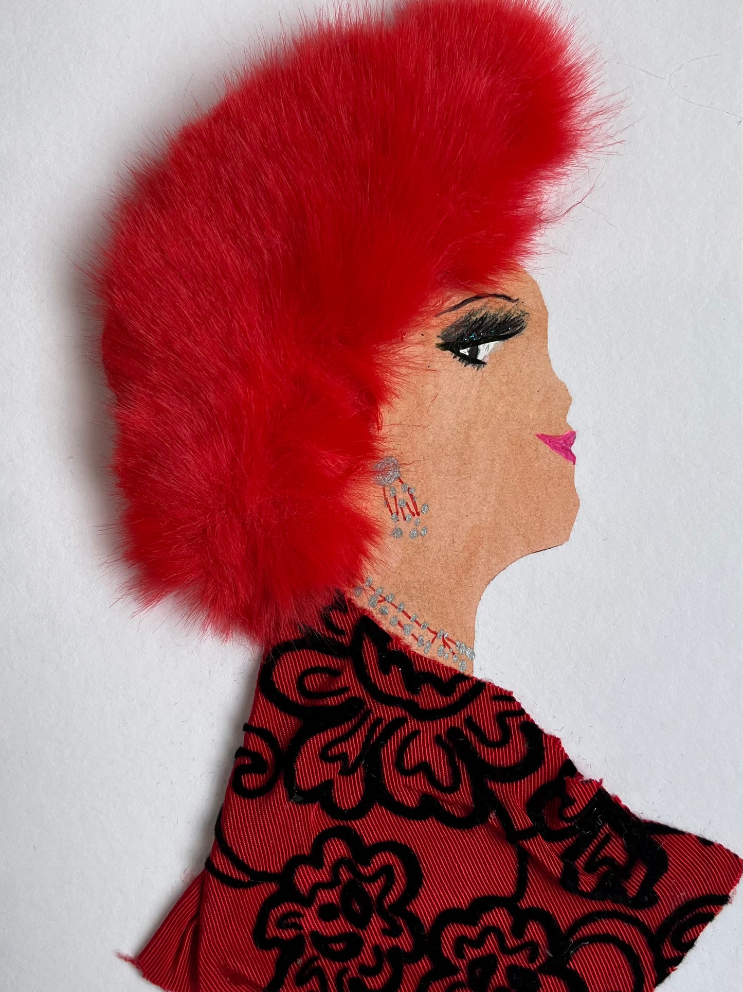 I designed this card of a woman named Sideny St. Thomas. She has a white skin tone and has on a vibrant red fury hat. She wears a blouse that is red with black floral embroidery. She wears silver and red jewellery.