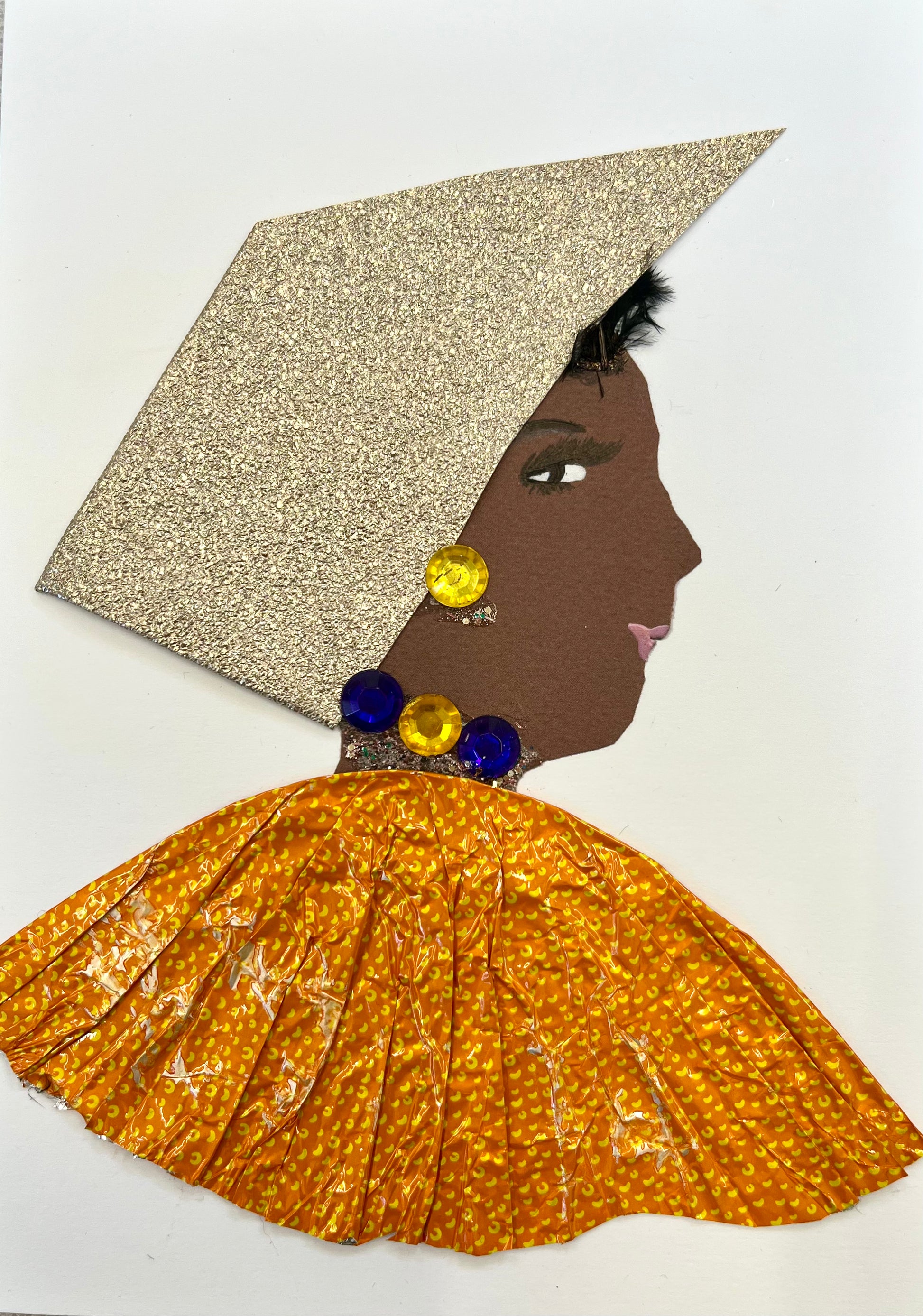 I designed this card of a woman named Ophelia Oxford. She has a brown skin tone and wears a sparkly silver hatinator with a yellow orange blouse. She wears blue and yellow gem jewellery.