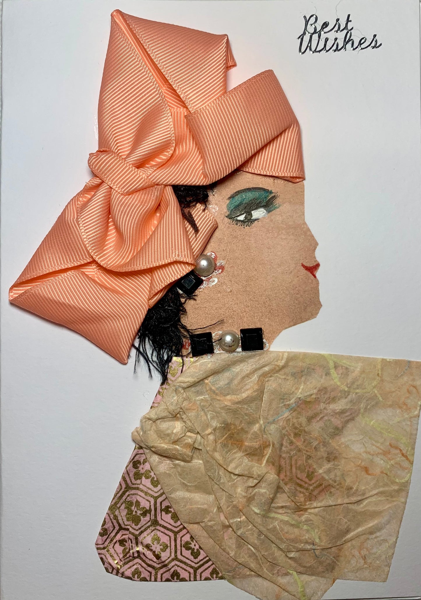 This card is called peach pamela. She wears a light coloured tissue material blouse and a large pink bow in her hair. On the top right corner, it says best wishes.