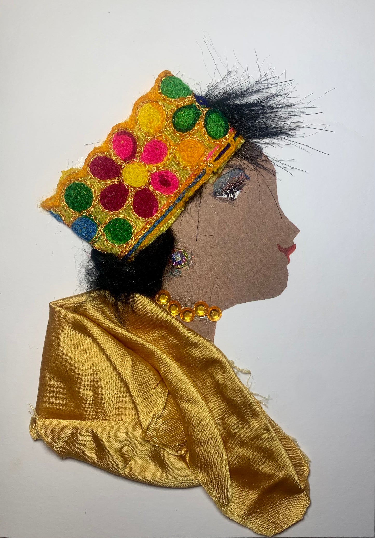 This card is called Rita. She wears a golden coloured blouse which matches her gemstone necklace, and a colourful hat which has different flowers on it.