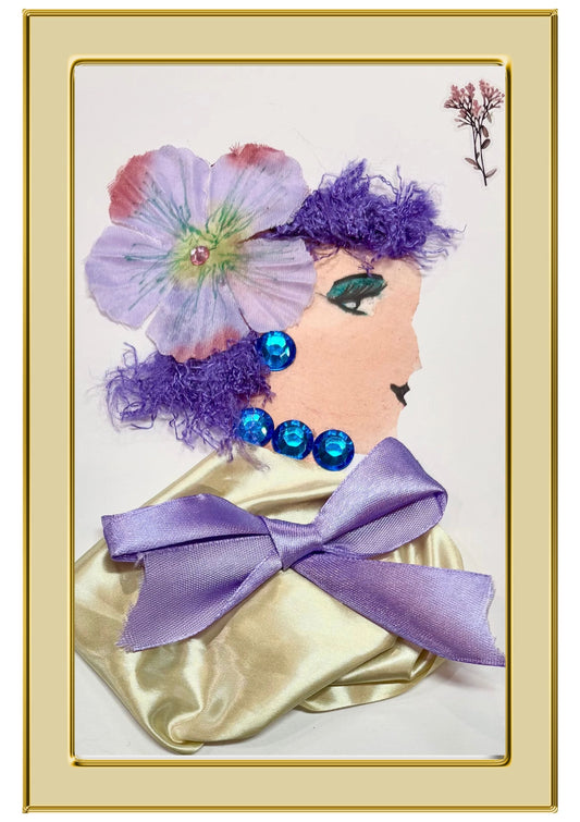 A handmade dayo card of a side profile of a lady with purple hair with a purple flower in it, wearing a gold shawl with a purple bow on it, as well as some blue gem jewllery