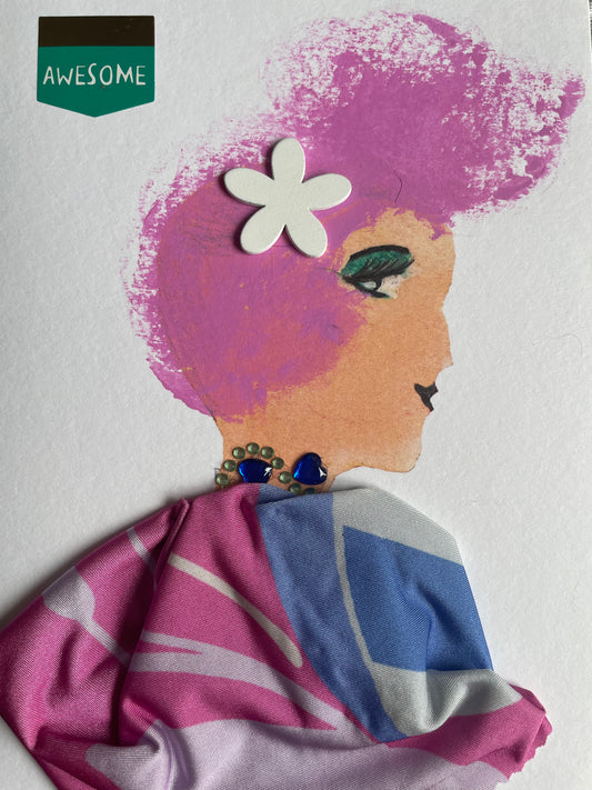 This card depicts a woman with pink hair and has a white flower tucked in her hair. She wears a pink and blue blouse and a blue and silver necklace.