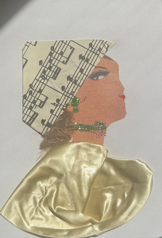 A handmade greeting card featuring a a womans silhouette adorned in shiny gold tones. She wears a metallic gold headwrap decorated with musical notes woven into the design, creating a rhythmic, music-inspired look. Her shawl has a reflective, shimmering finish that contrasts with the texture of the headwrap, adding layered dimension. Her garment is designed with a sheet music pattern that brings visual structure and flow to the composition. She is accessorized with a matching green jewllery set. 