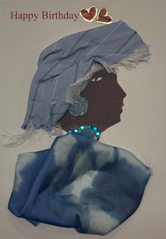 Handmade birthday card that can double as a piece of art featuring a woman wearing a blue headscarf and blue patterned outfit with a sparkling necklace. Two red heart decorations and the words “Happy Birthday” appear above the design.