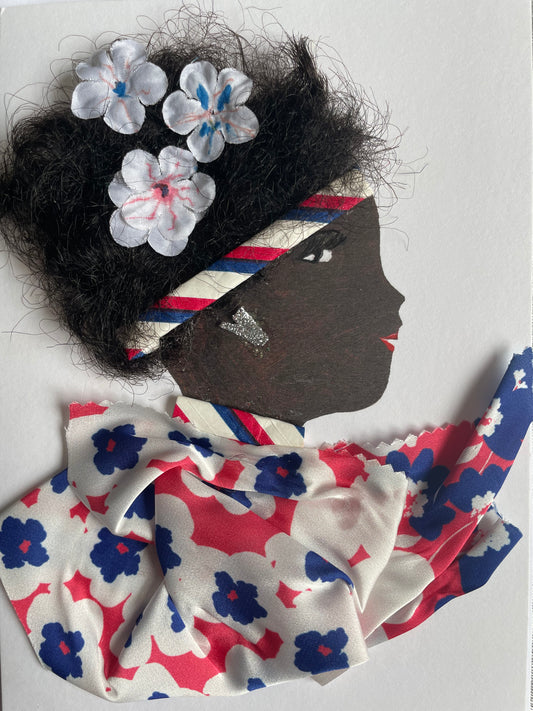 This card shows a woman wearing a blouse that is white with red and blue flowers. She wears a headband with a stripe pattern. She also has white flowers in her black hair