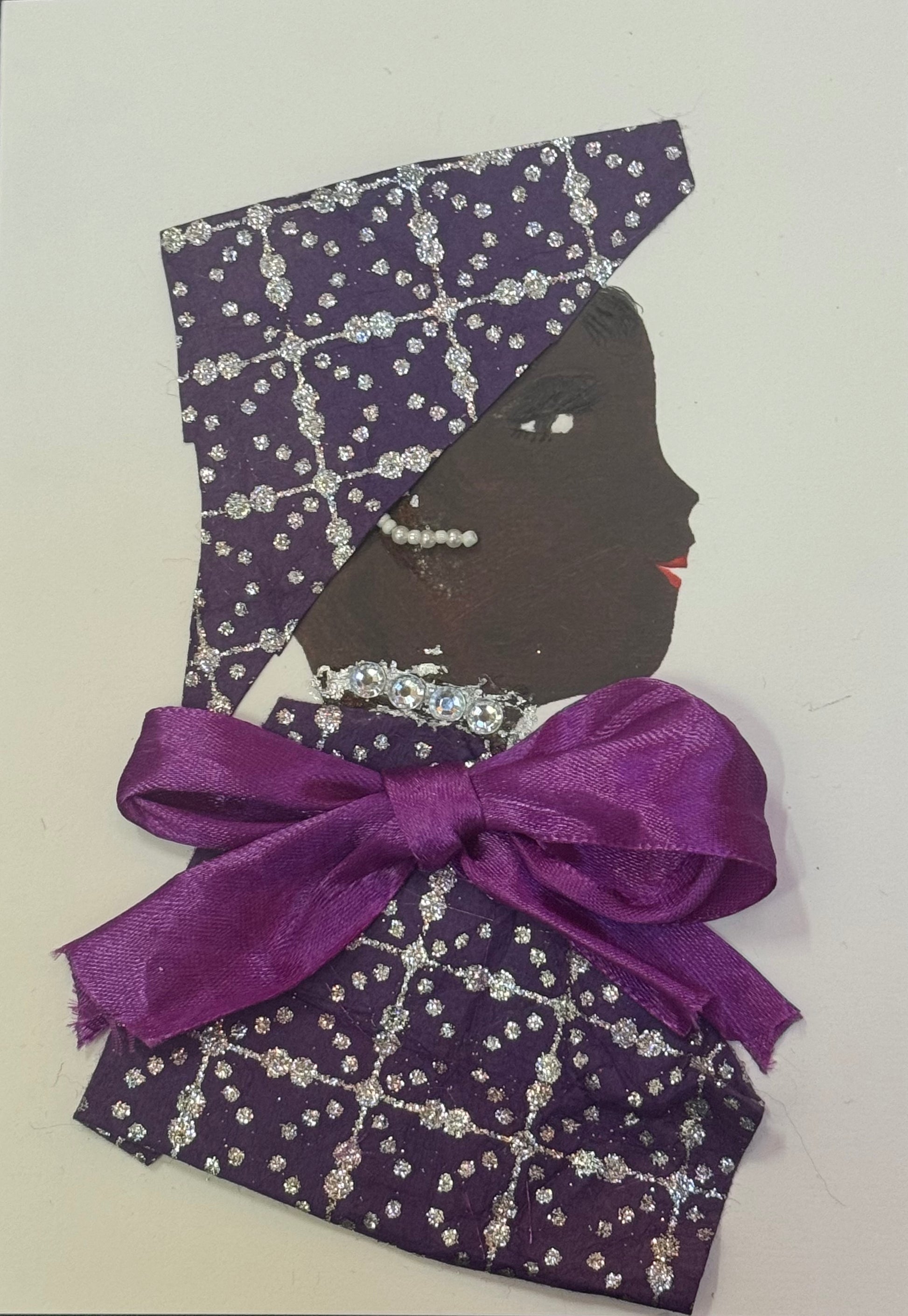 Handmade greeting card that can double as a piece of art featuring a side-profile collage of a woman with dark skin wearing a structured purple patterned headpiece, with a matching blouse that has a sliver glitter patteren embroidered onto both. She also wears pearl earrings, a jeweled necklace, and a large satin bow at the neckline.