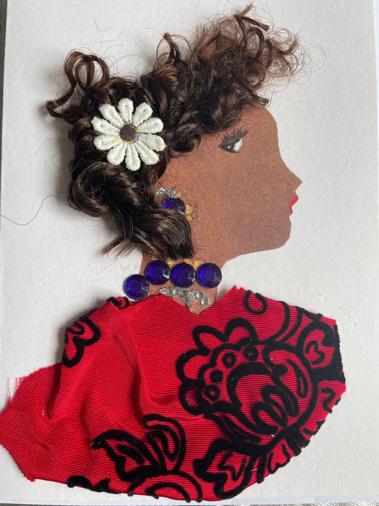 This card depicts a woman with curly brown hair and a white flower pin in her hair. She wears a red blouse with a black floral pattern. She also wears a blue and silver necklace and earrings. 