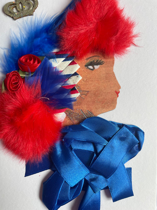 This card shows a woman who wears a blue headpiece with her red hair. This headpiece has roses tucked into it. She wears a blue blouse. She also wears silver jewellery.