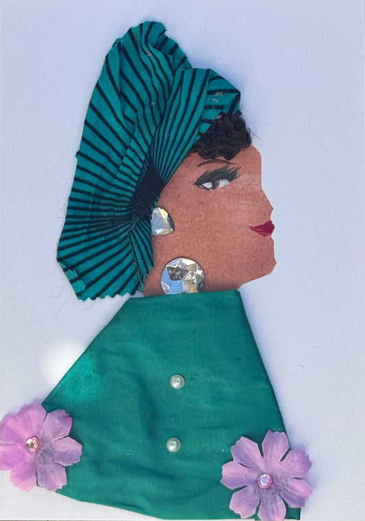 Handmade greeting card that can double as a piece of art featuring a womans side profile who is wearing a teal headwrap with black line patterns across it. She wears a similar coloured shawl but it is plain green without the partern, also has light purple flowers embroidered at the bottom of each corner. There are also two small pearl details on the shawl down the middle as an accent or acting like buttons. For jewllery she wears large silver gems for a neckalce and earrings. 