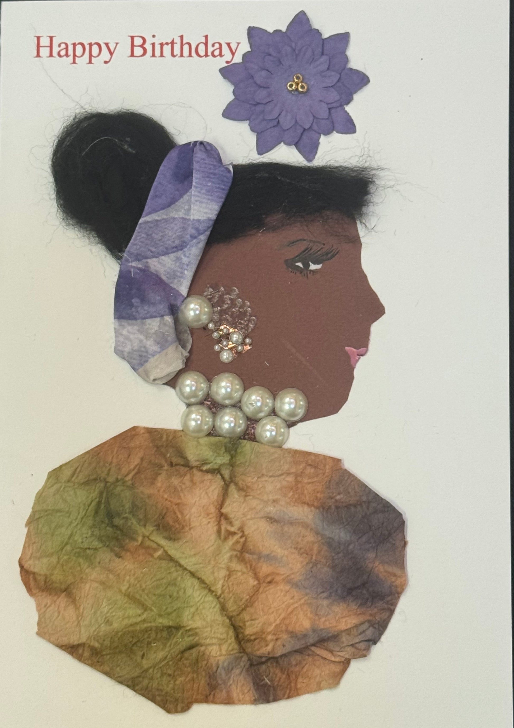Handmade greeting card that can double as a piece of art featuring a side-profile collage of a woman with dark skin, wearing a purple headband and large pearl jewelry, dressed in earthy-toned fabric, with “Happy Birthday” text and a purple flower above her.