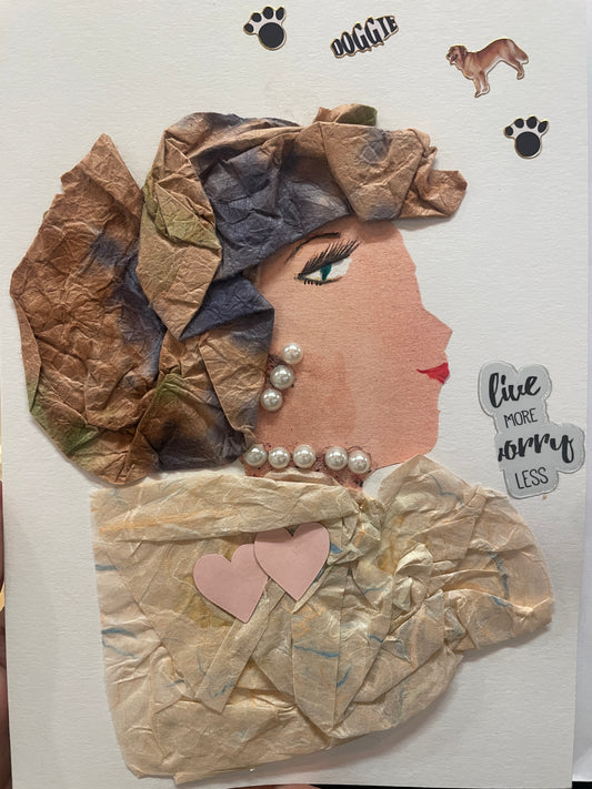 This is a handmade card of a woman named Addison with a crinkled brown and green headwrap, pearl necklace, and a cream tissue-paper outfit. Stickers of hearts, dogs, and paw prints surround her.