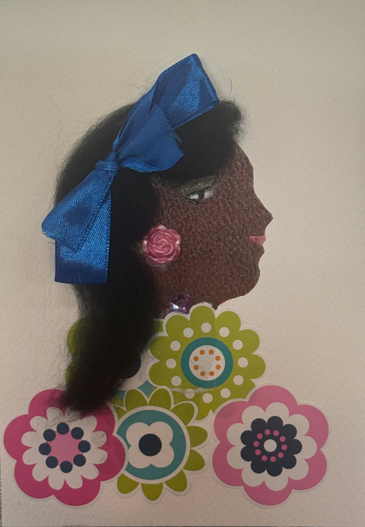 Handmade card that can double as a piece of art, depicting a woman with curly dark brown hair, wearing a large blue bow headband. She also wears a bright pink rose earring and a purple bead necklace. Bright colorful flowers embody the shape of her blouse, creating a lively and joyful floral design. The layered flowers vary in size and color, adding texture and depth across the lower half of the composition. The overall palette feels vibrant and playful, with bold blues, pinks, and purples standing out 