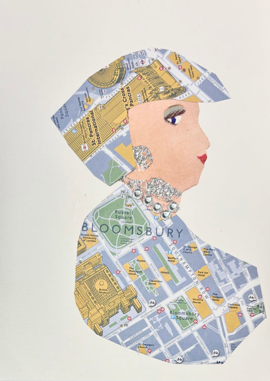 A woman wears a matching hat and blouse featuring a map pattern of Bloomsbury. She wears a silver earring and necklace. 