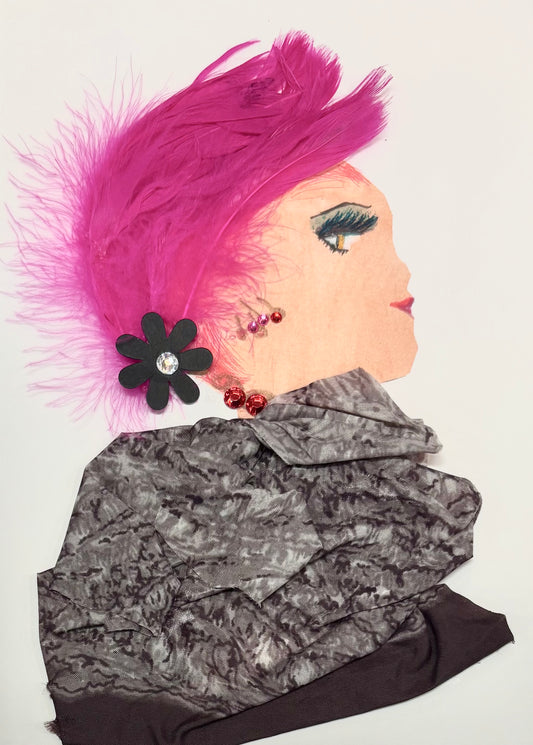 A woman has bright pink hair made of feathers and a black flower as an accessory. Her blouse is grey with some black mixed. She has dainty red earrings and a necklace. 