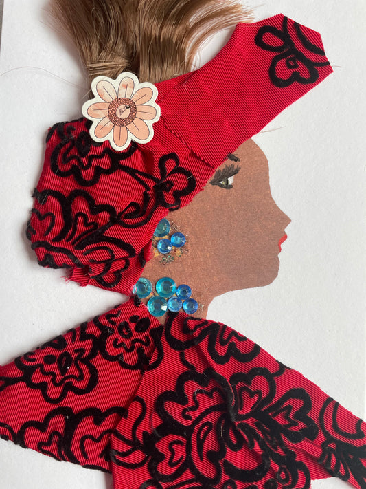 This card shows a woman who wears a matching headpiece and blouse with red and black floral patterns printed on both. She has a pink flower pin attached to her headpiece. She also is wearing blue jewellery.