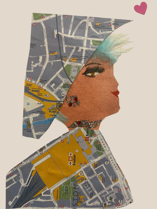 This is a handmade card of a woman named Camden Ashby. She wears a wrap and dress made of a detailed printed London map. Her look is finished with red gemstone earrings and necklace, a teal feather fringe, and a pink heart sticker floating above her head.