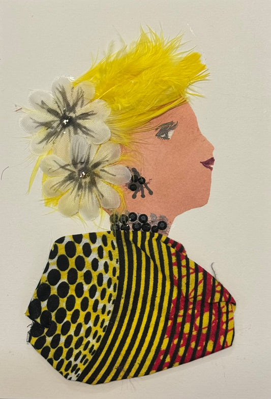Handmade greeting card that can double as a piece of art featuring a side profile collage of a woman with bright yellow feathered hair and large floral decorations near her ear. She wears patterned fabric clothing in yellow, black, and red, along with black beaded jewelry for a neckalce a matching earring set.