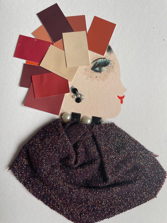 The card depicts a woman who wears a brown blouse that shimmers. She also wears black and white jewellery. She wears a hat that is made of strips of paper that are various shades of brown.