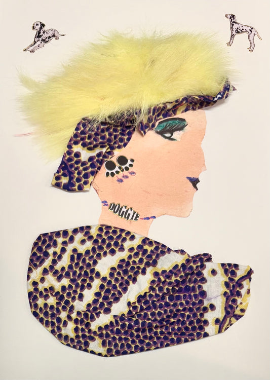 A woman has fuzzy yellow hair and a multicoloured headband. The headband and blouse feature purple dots clustered together with white and yellow. She has paw print earrings and a "doggie" necklace. Two dalmations are pictured on the card, one in the top left corner and one in the top right corner. 
