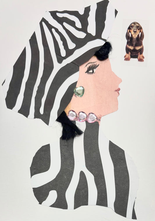 A woman wears a matching zebra print hat and blouse. She has a pale green heart gem earring and a pale pink necklace. A dachshund is is pictured in the top right corner of the card. 