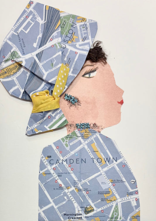 A woman wears a matching hat and blouse with a map featuring Camden. She wears sparkly blue jewellery. 