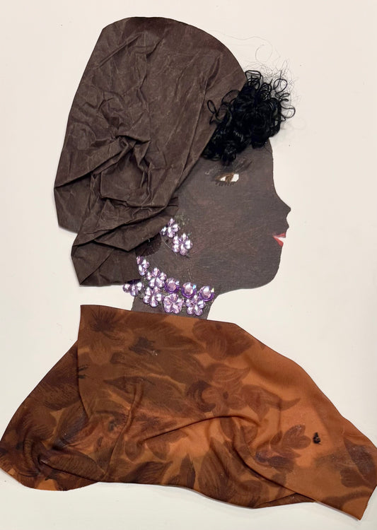 This is a handmade card of a woman named Dr Ella Elegant. She wears a tall brown headwrap made from soft, crinkled fabric and a flowing brown garment with a subtle floral pattern. Her jewelry is crafted from clustered purple gems arranged at her neck and ears. She has short, curly black hair peeking out and a serene expression with gentle eyes and red lips.