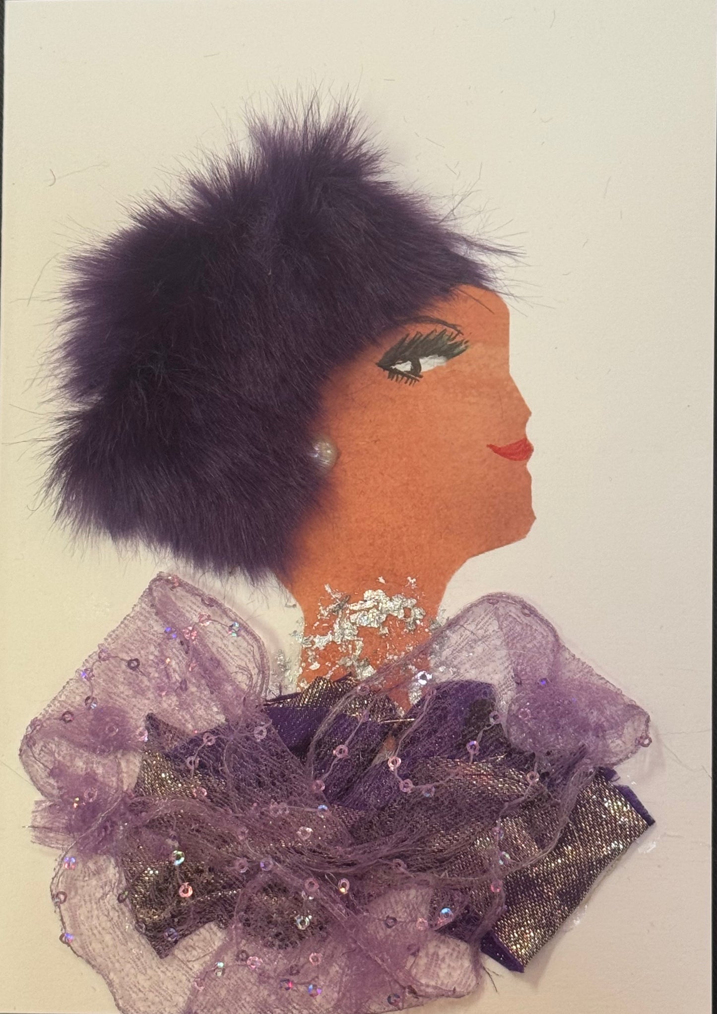 Handmade greeting card that can double as a piece of art, featuring a side-profile collage of a woman with warm-toned skin wearing a fluffy purple hat and layered lavender tulle outfit, accented with sparkles and sequins around the neckline.