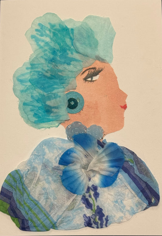 A side-profile collage portrait of a woman facing right, with soft peach-toned skin and a large, voluminous blue headpiece made of sheer, layered fabric resembling petals or waves. She wears a circular blue earring and a translucent blue necklace-like embellishment. Her outfit is composed of layered blue fabrics with floral patterns and a prominent blue-and-white flower at the center of her chest. Her eye is detailed with long lashes and dark liner, and her lips are red. The textures are light and airy.