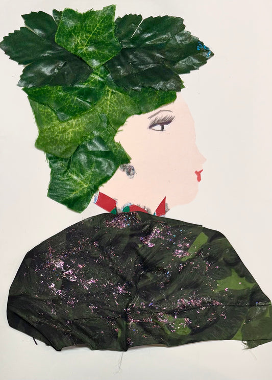 A woman wears green leaves as a hat and a dark green blouse with pink sparkles. She has a red necklace. 