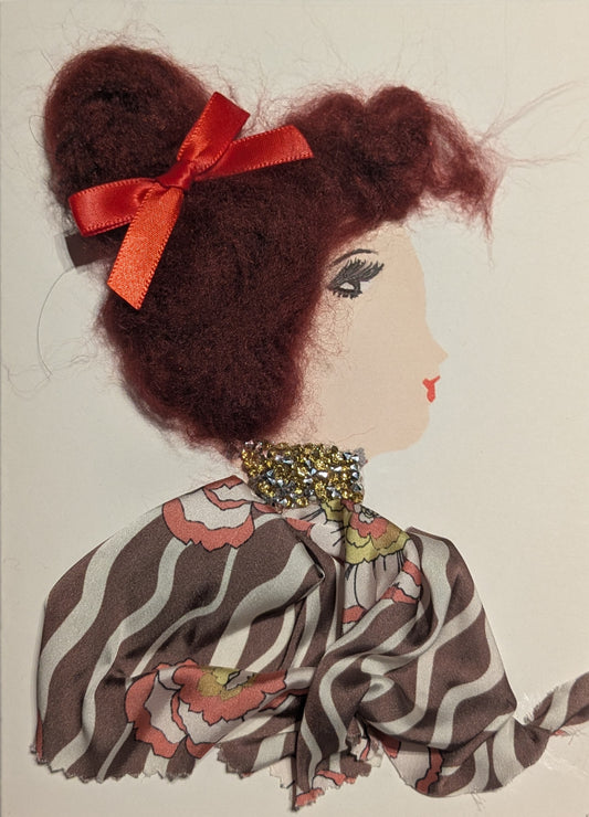 This is a handmade card of a woman named Garnet Crescent. She has deep red textured hair styled in a bun with a bright red ribbon. She wears a patterned fabric outfit with waves and floral shapes in brown, white, red, and yellow. Around her neck is a chunky collar made of gold and silver gems.