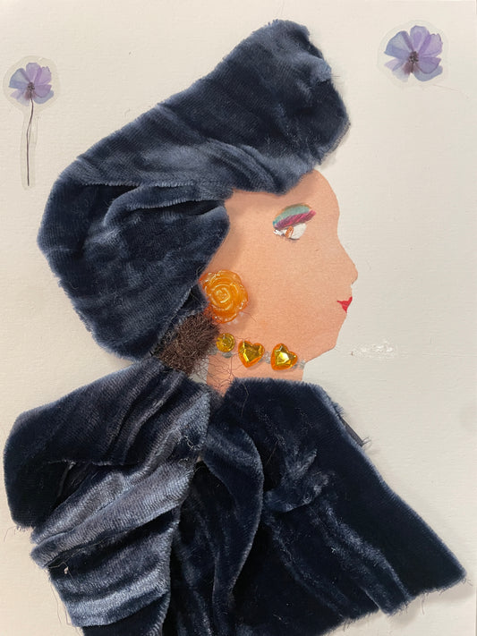 This is a handmade card of a woman named Georgia Greenwich. She wears a dark velvet outfit and wrap with yellow heart-shaped embellishments and an orange flower earring.