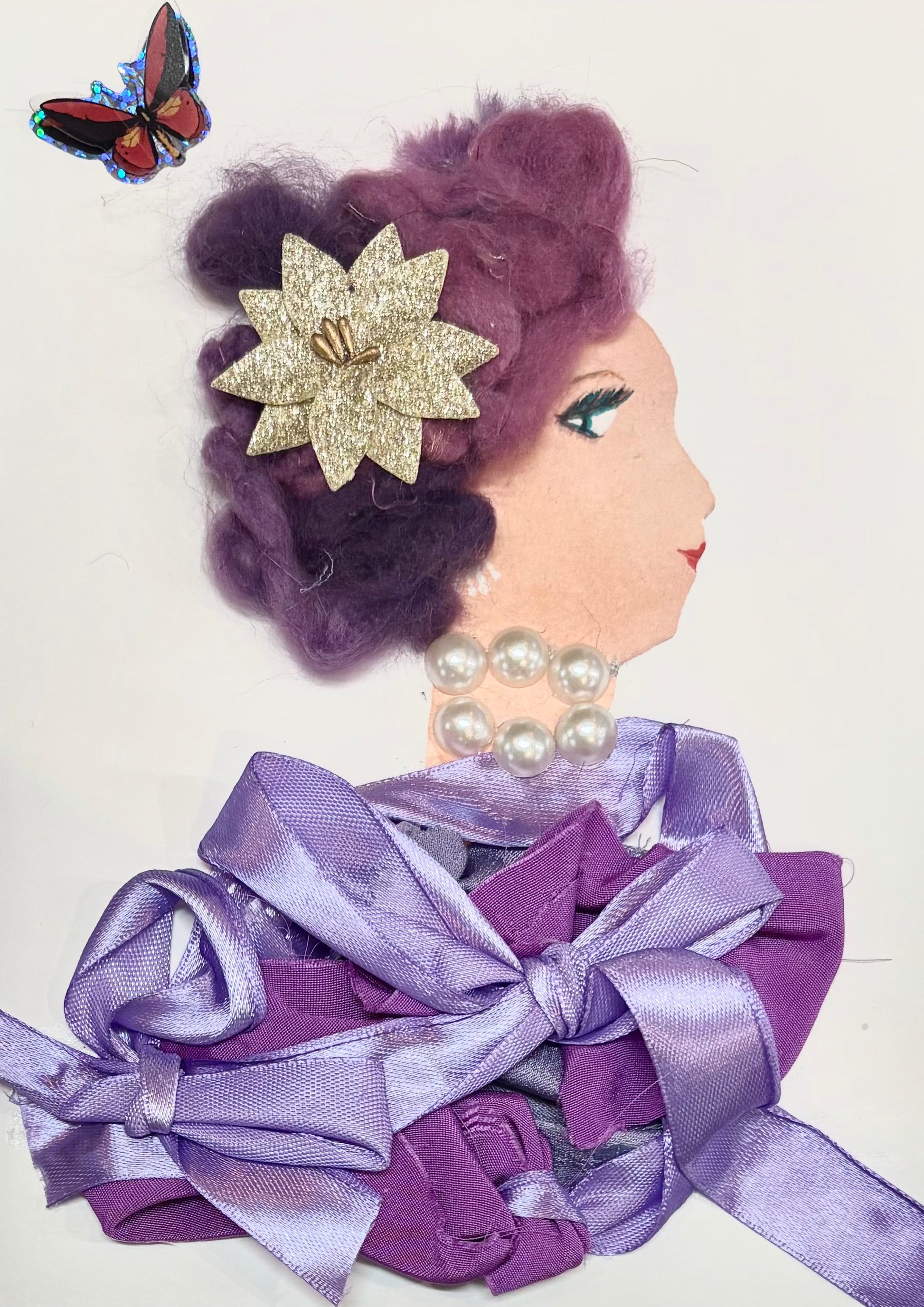 A woman has purple hair and a gold flower in her hair. Her blouse is made up of bows in varying shades of purples. She also wears a pearl necklace. A butterfly is featured in the top left corner of the card. 