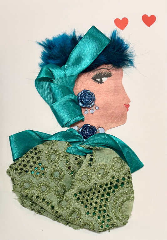 A woman has short blue hair and a teal ribbon as a hair accessory. She wears a green, lace-like blouse and a teal bow around the top. She wears blue jewellery in the shape of roses. Two hearts are found in the upper right corner. 