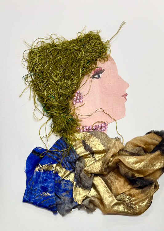 A woman has olive green hair and a multicoloured blouse with gold, blue, and caramel brown. She wears an earring and necklace that are made of little pink gems. 