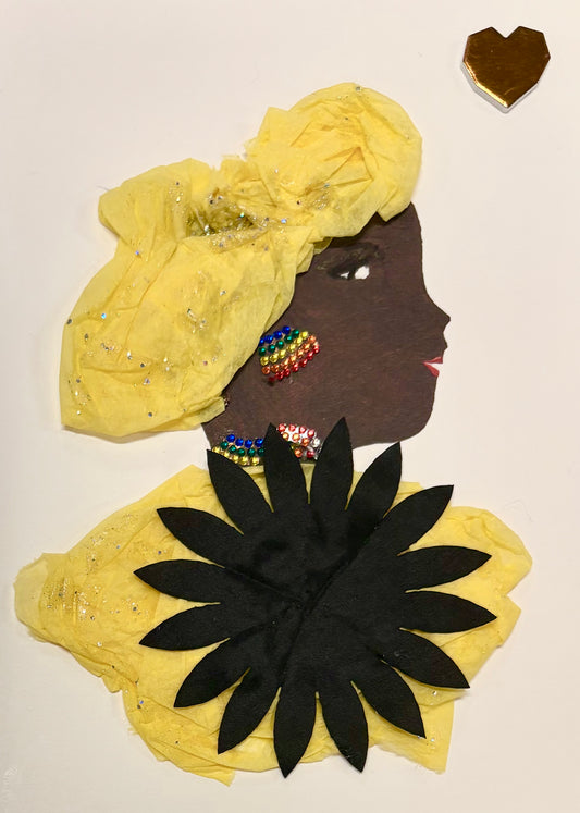 A woman wears a yellow headwrap that sparkles mildly with a yellow blouse. A large black flower covers most of her blouse. She wears rainbow earrings and a matching rainbow necklace. There is a geometric looking heart in the top right corner of the card. 