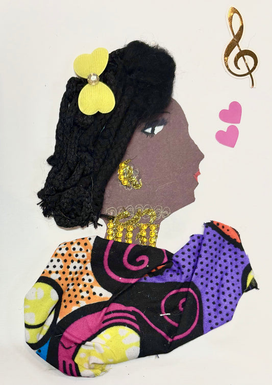 I handmade this card of a woman named Lady Hammersmith. She’s shown in profile with black braided yarn hair, styled up and adorned with a yellow flower embellishment. Her earrings and neckline sparkle with golden rhinestones and delicate drawn details. She wears a bold, multicoloured patterned fabric in purple, orange, pink, yellow, and black. Floating nearby are two pink hearts and a golden treble clef, celebrating her radiant, artistic spirit.