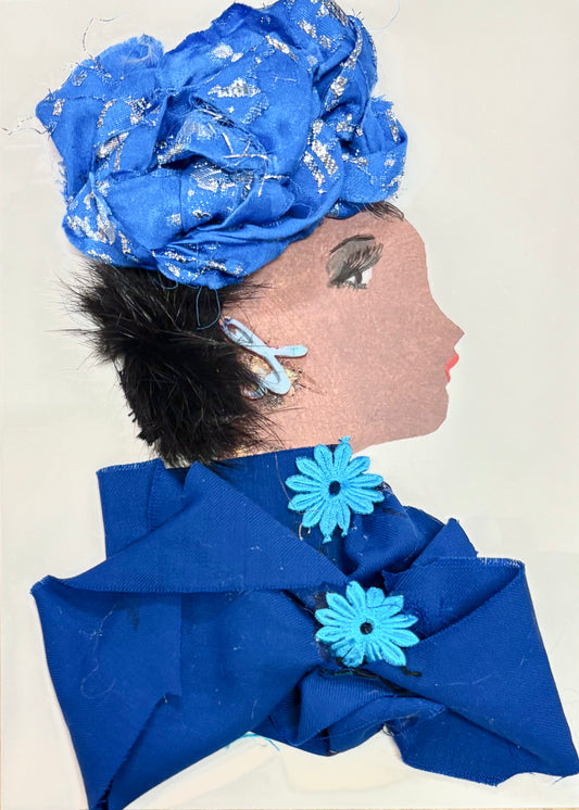 A handmade greeting card featuring a collage of a woman in profile, decorated with bright blue fabric for her headwrap and outfit, faux fur for hair, and blue flower embellishments.